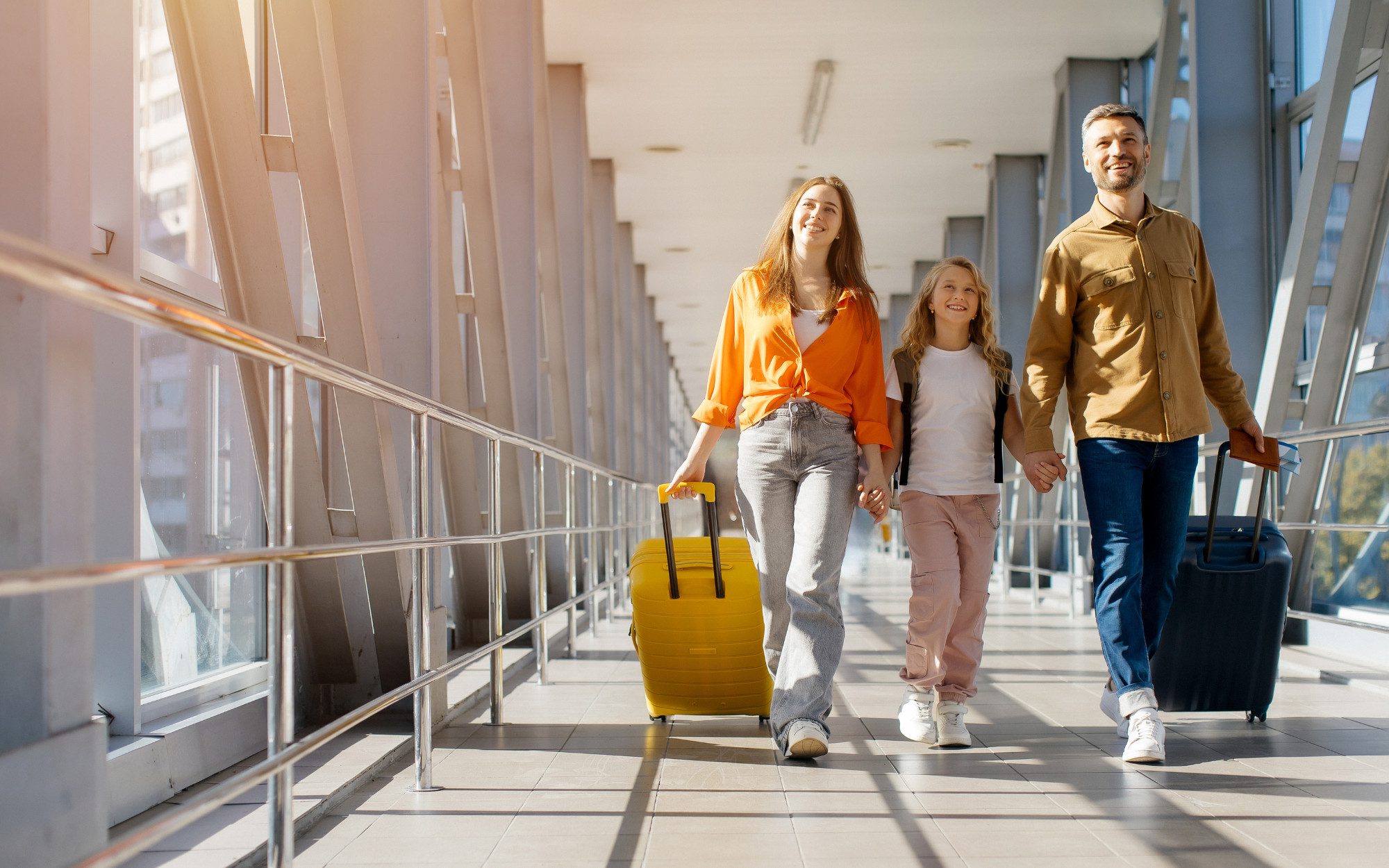 Family walking towards boarding gate at the airport