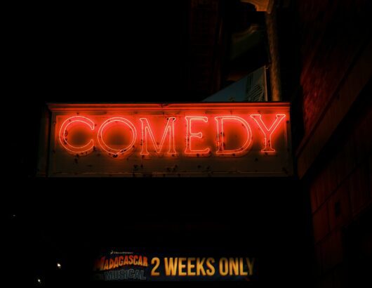 The image of the lighten up "comedy" sign