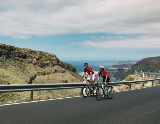 The image of two cyclists in the mountains